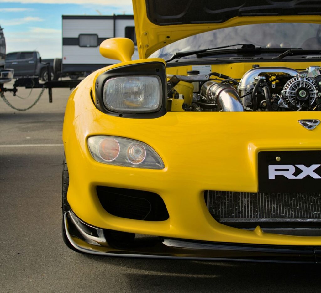 Yellow RX-7 with the bonnet up
