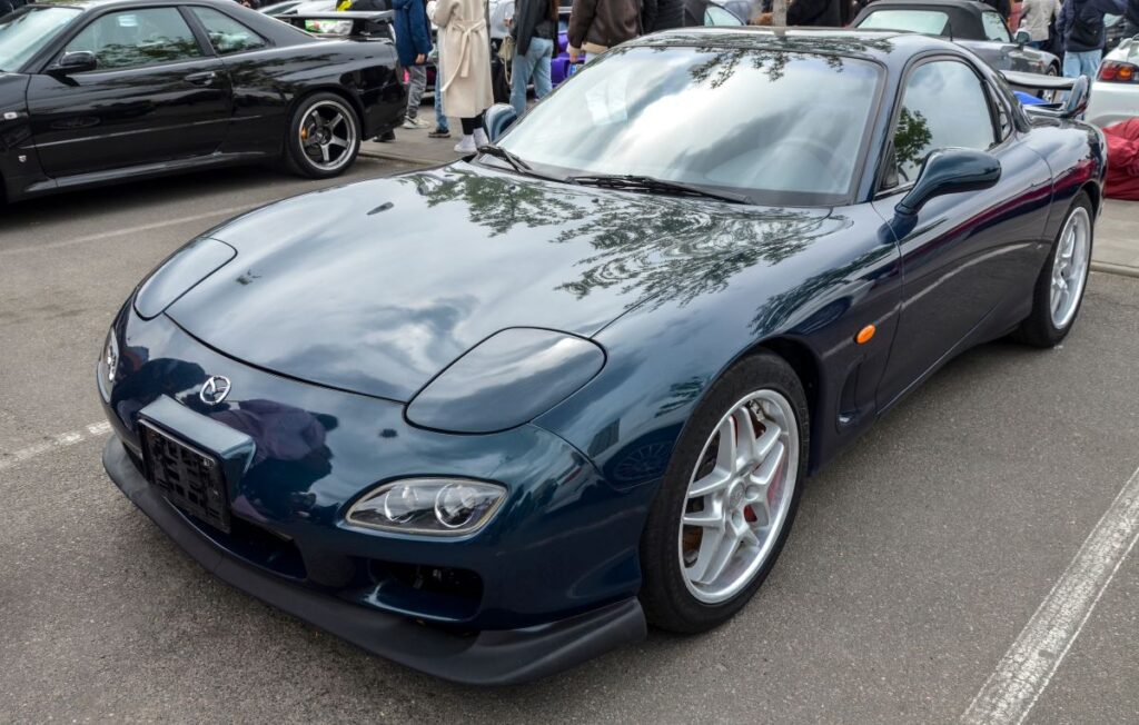 Dark blue Mazda RX-7 (FD) known for its organic, timeless design is celebrated as one of the most beautiful and technically advanced sports cars of the 1990s