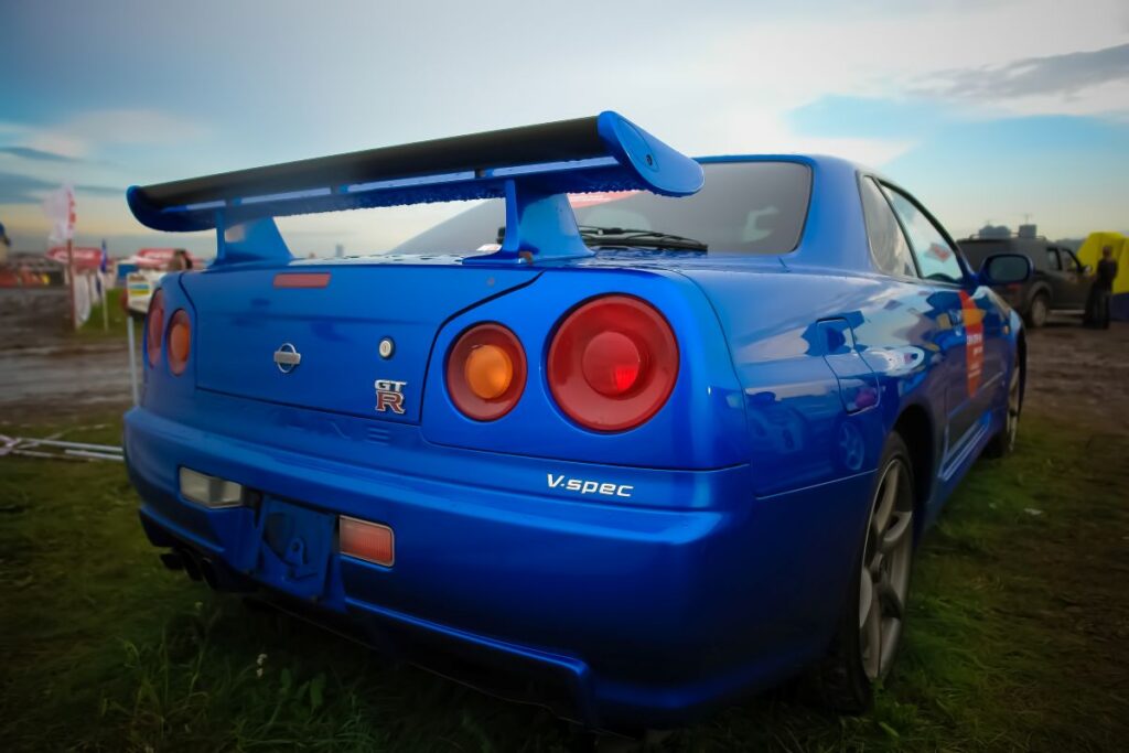 The blue colour Nissan Skyline GTR R34 on grass