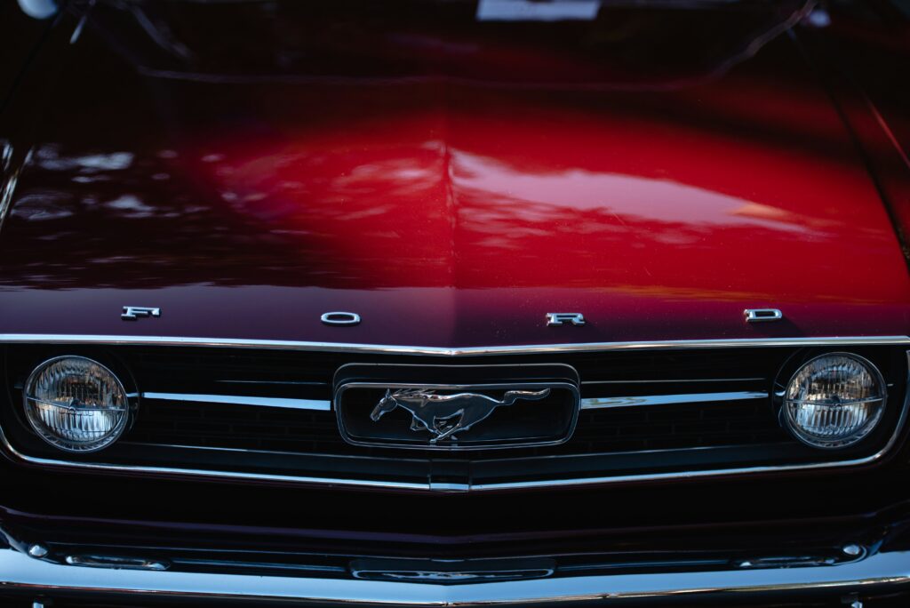front of a red ford mustang